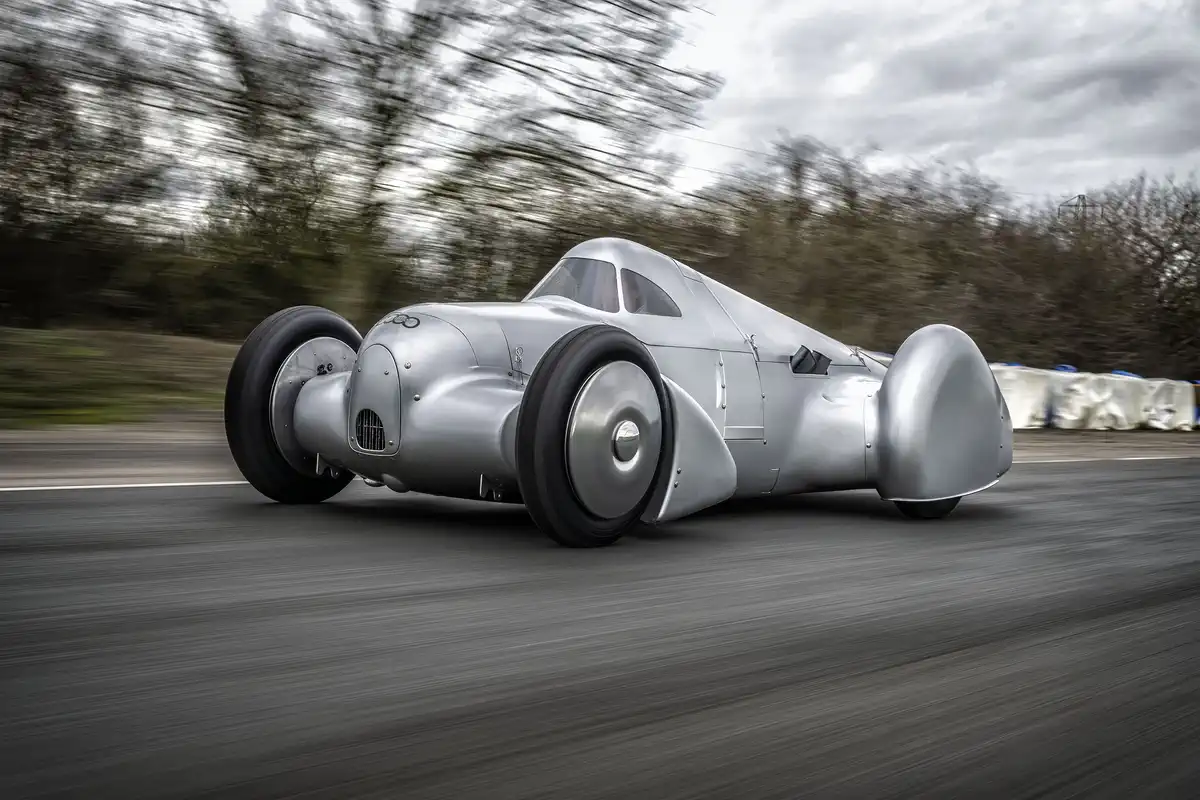 Компанія Audi відтворила модель Auto Union Lucca. Після трохи більше ніж трьох років будівництва цей рекордний автомобіль був завершений на початку 2026 року.Кадр з першої випробувальної поїздки. Вигляд збоку.